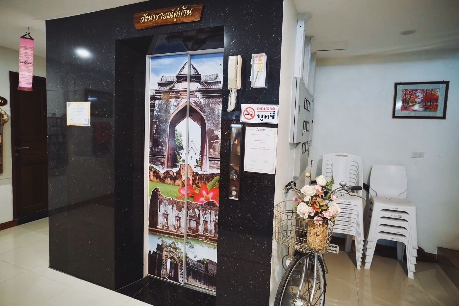 Lift lobby, decorated with Lopburi artwork on the lift doors