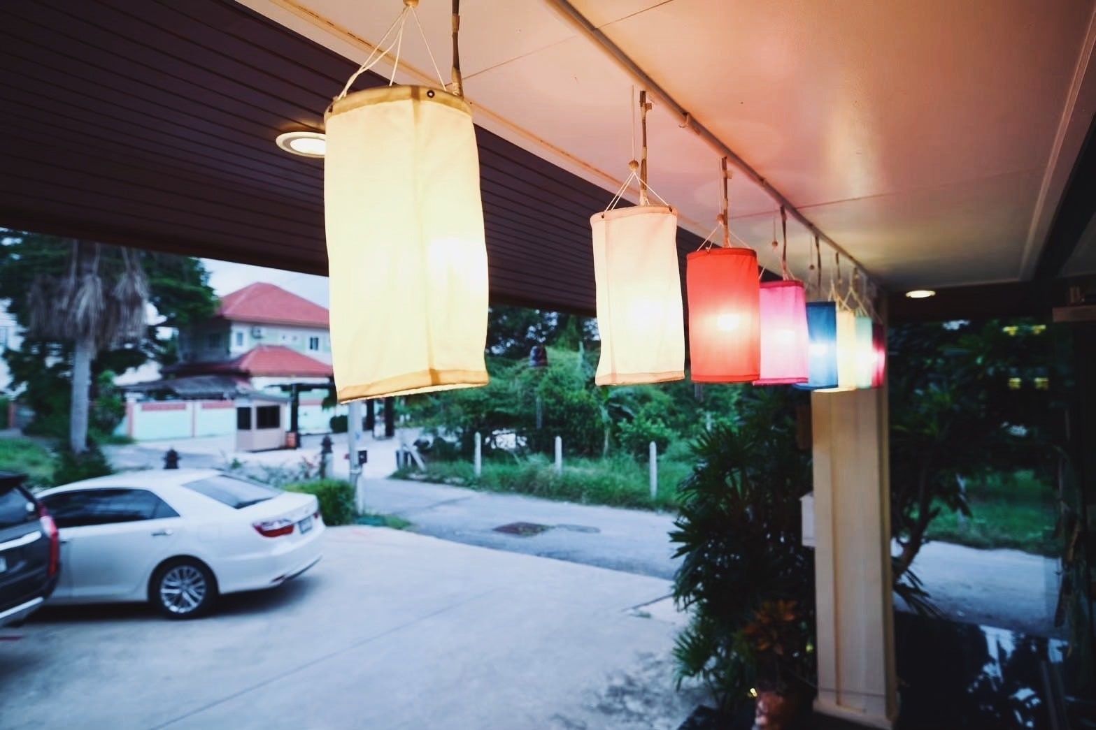 Lanterns at the porch, looking out to the car park and street